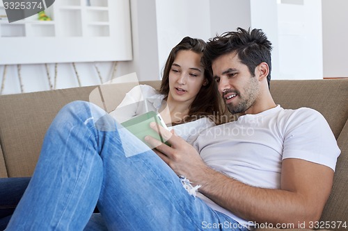 Image of couple at modern home using tablet computer