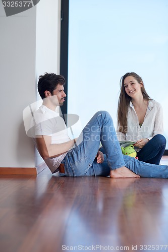 Image of relaxed young couple at home staircase
