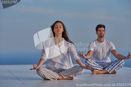 Image of young couple practicing yoga