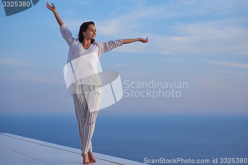 Image of young woman enjoy sunset