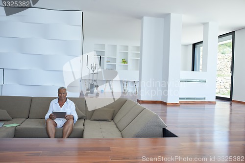 Image of Portrait of senior man relaxing in sofa