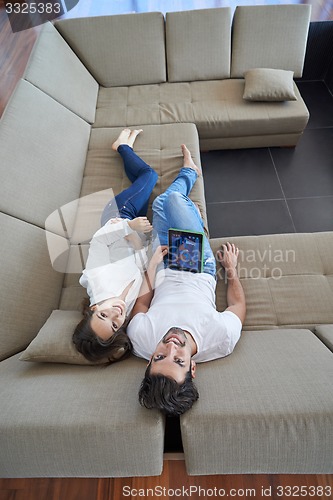 Image of couple at modern home using tablet computer