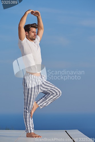 Image of young man practicing yoga