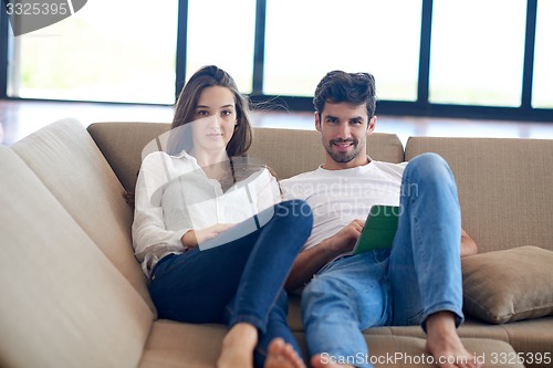 Image of couple at modern home using tablet computer