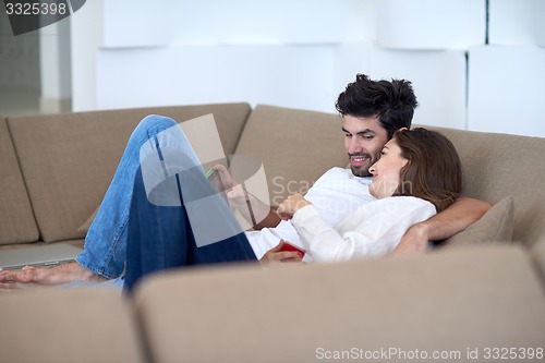 Image of couple at modern home using tablet computer
