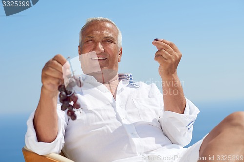 Image of senior man sitting outside