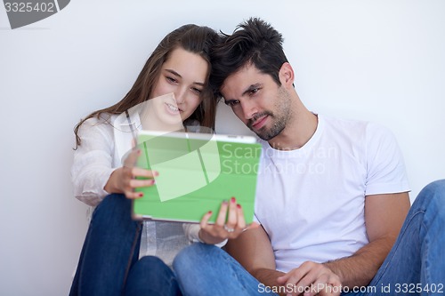 Image of couple at modern home using tablet computer