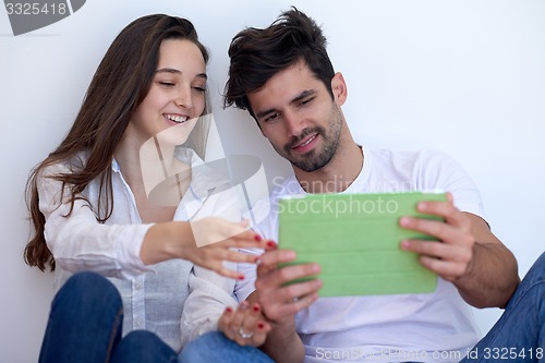 Image of couple at modern home using tablet computer