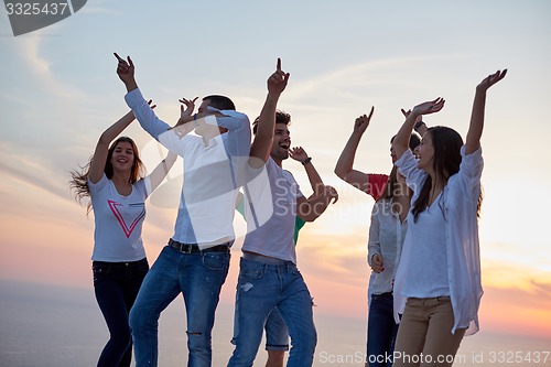 Image of party people  on sunset