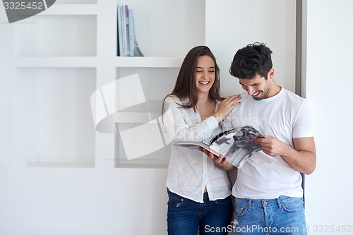 Image of relaxed young couple at home staircase