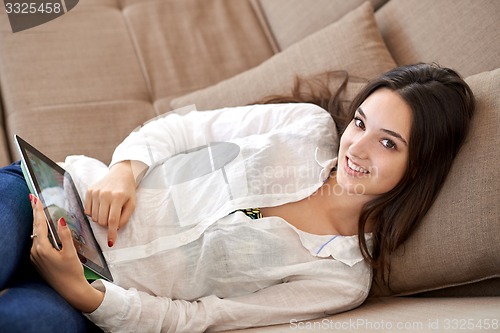 Image of woman at home using tablet