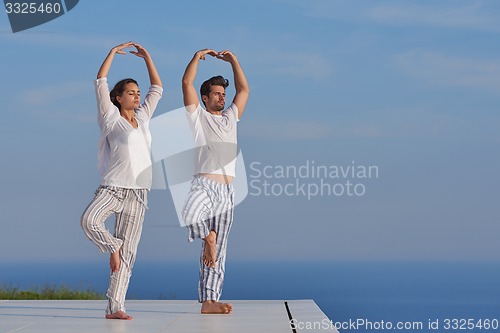 Image of young couple practicing yoga