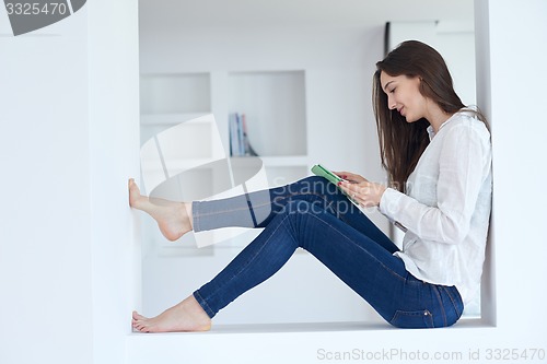 Image of woman at home using tablet