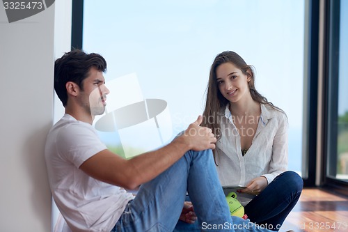 Image of relaxed young couple at home staircase