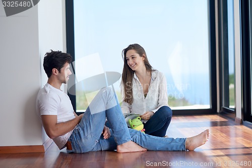 Image of relaxed young couple at home staircase