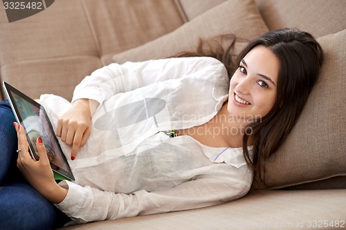 Image of woman at home using tablet