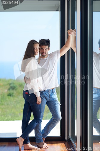 Image of relaxed young couple at home staircase