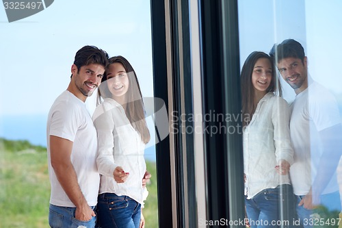 Image of relaxed young couple at home staircase