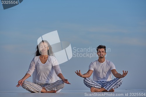 Image of young couple practicing yoga