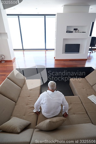 Image of Portrait of senior man relaxing in sofa