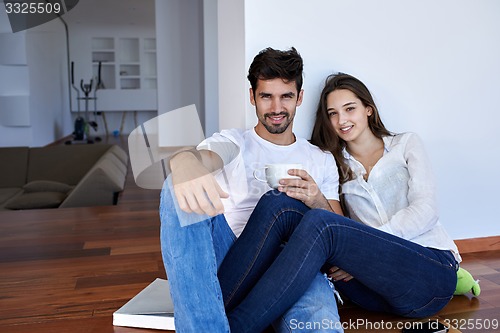 Image of relaxed young couple at home staircase