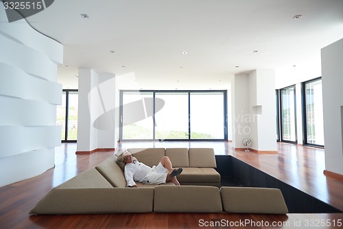 Image of Portrait of senior man relaxing in sofa