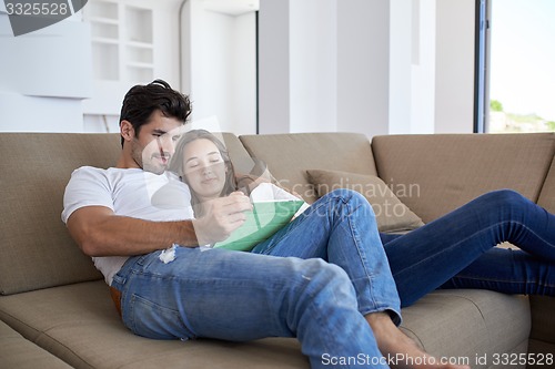 Image of couple at modern home using tablet computer