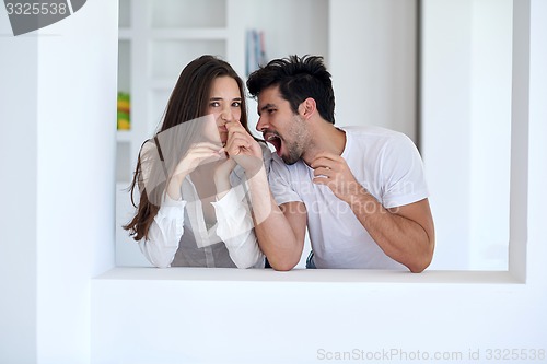 Image of relaxed young couple at home staircase