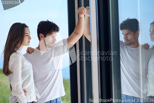 Image of relaxed young couple at home staircase