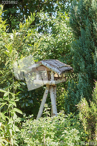 Image of Three-legged wooden bird table