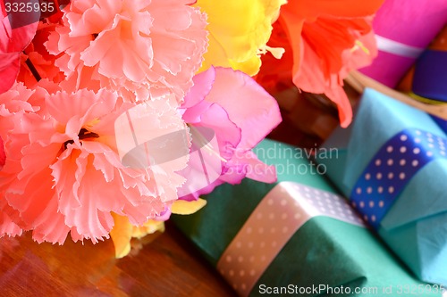 Image of present gift box and flower bouquet on silk