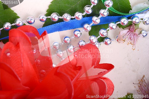 Image of Office table with ribbons, flowers, pencils and pearls