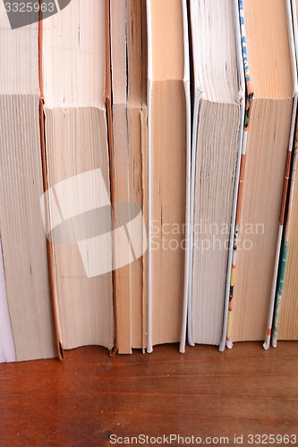 Image of Old books leaning against each other for sale
