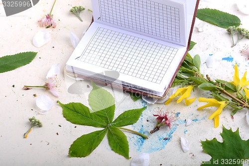 Image of Blank paper notebook on white vintage background with scrapbooking elements