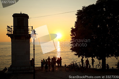 Image of Tourists watching sunset