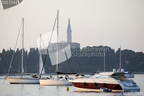 Image of Saint Euphemia bell tower and anchored sailboats