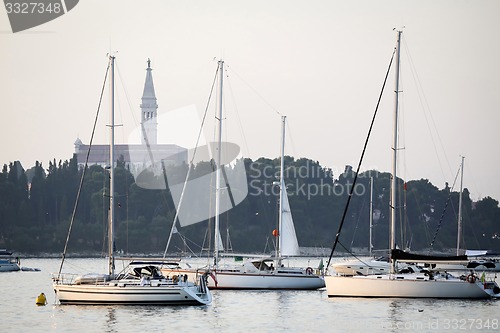 Image of Anchored sailboats in front of Saint Euphemia bell tower