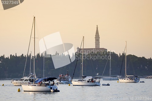 Image of Sailboats anchored in Rovinj harbour at sunset