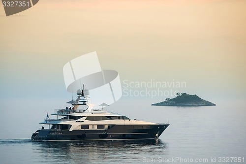 Image of Yacht sailing at sunset