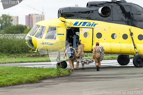 Image of Rescuers load into helicopter MI-8 