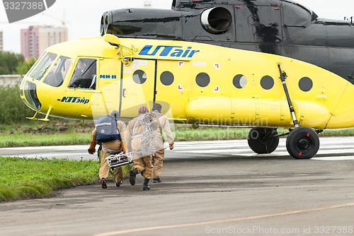 Image of Rescuers load into helicopter MI-8 