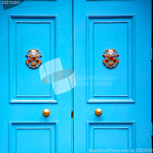 Image of  blue handle in london antique brown door  rusty  brass nail and