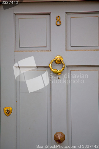 Image of handle in london antique brown door  rusty  brass nail and light