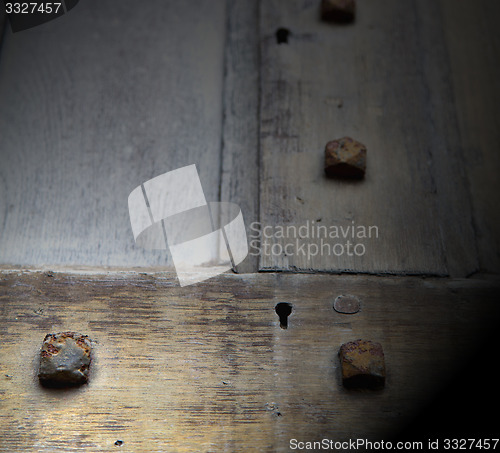 Image of in london antique brown door  rusty  brass nail and light