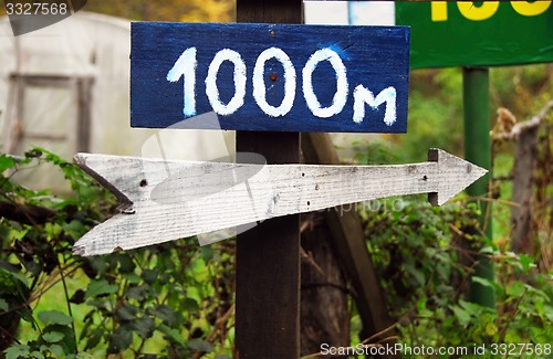 Image of Rustic wooden road direction sign