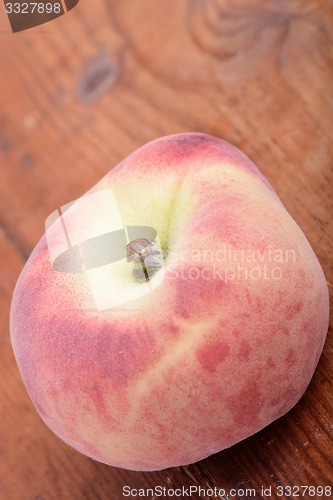 Image of peaches on the wooden background