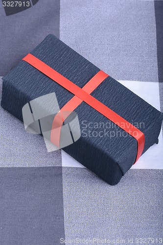 Image of Black gift box with red ribbon