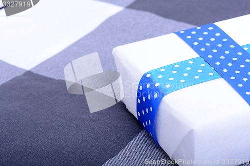 Image of White gift box with blue ribbon