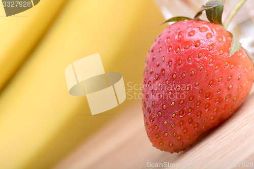 Image of healthy strawberry smoothie with fruits on wooden background