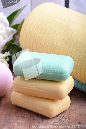 Image of towels set, aroma therapy, soap and sea salt on wooden plate 